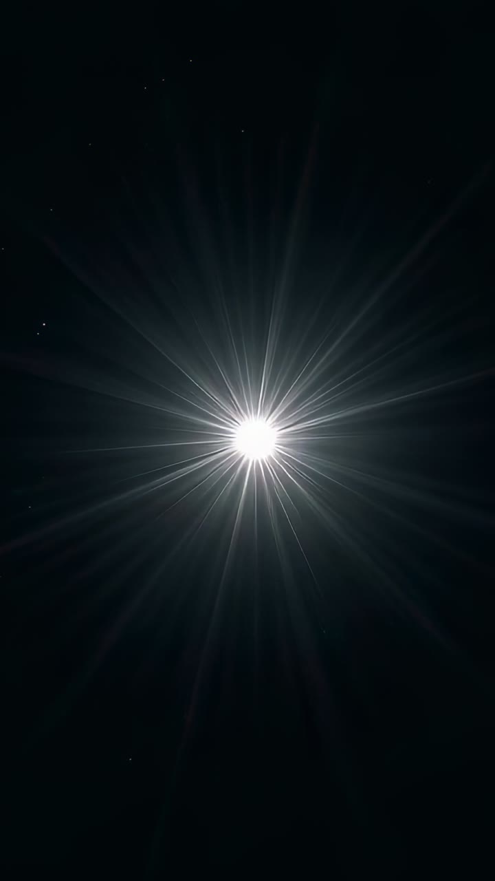 Vertical video: Flaring bright core shifting rays at night showing faint stars upper-left, treetops