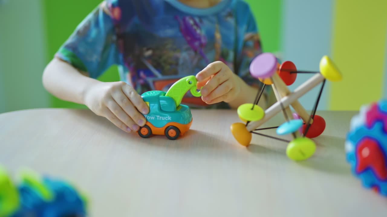Child playing at home. Close up view of small boy playing at table