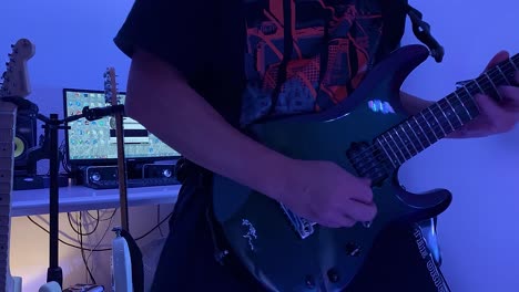 a guitarist plays guitar in his studio