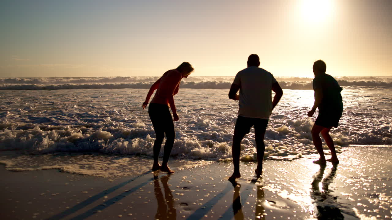 People enjoying time on the beach at sunset