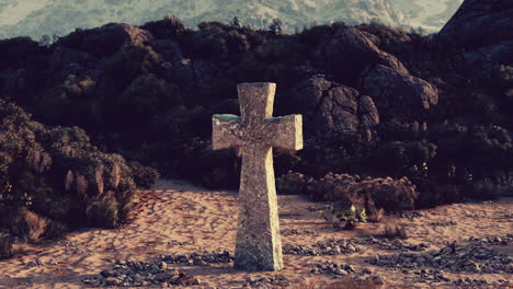 cruz de piedra en un paisaje desértico