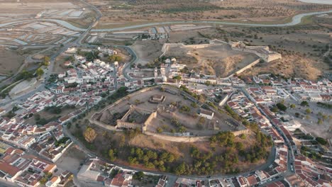 Vast-landscape-aerial-descending-shot-of-hilltop-Castelo-de-Castro-Marim-and-fort-of-sao-sebastiao