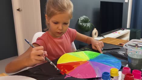 little girl painting a color wheel