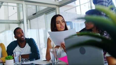 executives having discussion over document