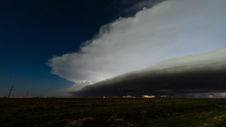 Electrified thunderstorm under starry skies with lightning flashing