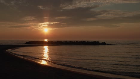 wide static shot of a sunset on the beach