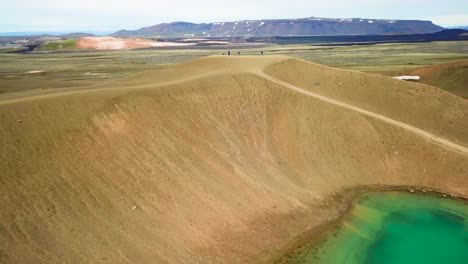 Beautiful-drone-shot-of-the-Krafla-geothermal-area-in-Iceland-with-green-lakes-and-steaming-hot-pots-4