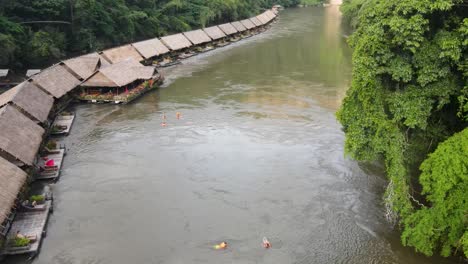 aerial view of string of floating hotels along the river kwai