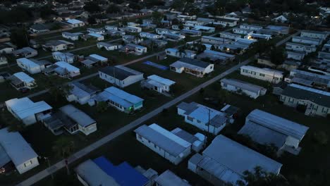 mobile trailer homes in quiet suburbia of american town. night scene in cheap and social district of plant city, florida. aerial birds eye shot. sleeping american neighborhood
