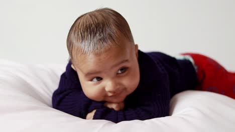 infant boy lying cute facial expression with white background at indoor