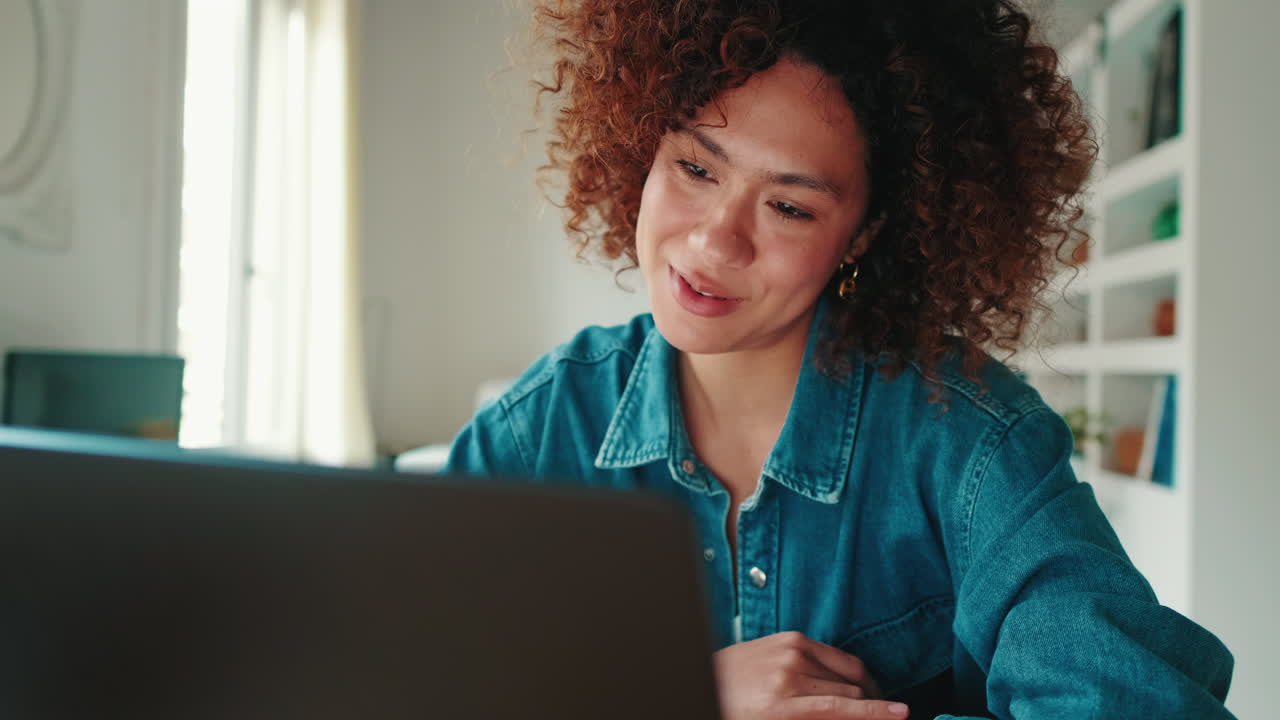 Happy Young Woman Smiling and Talking on Video Call via Laptop