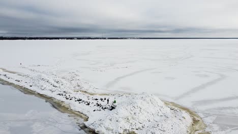 aerial drone view of a frozen mole in the middle of a frozen sea