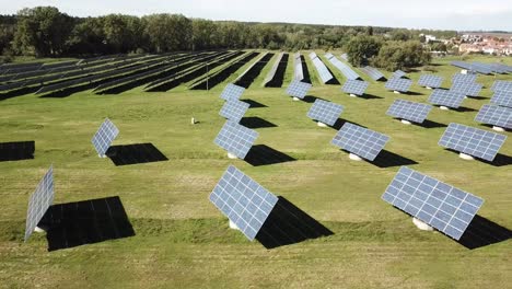 Solar-Panels-On-Green-Fields-During-Summertime-Near-Rural-Village