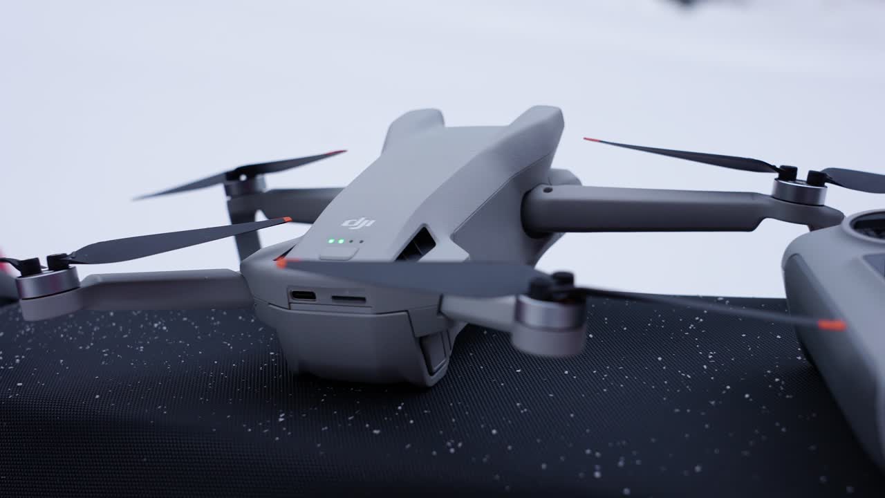 Close-Up of a Drone with Extended Propellers on a Snowy Background