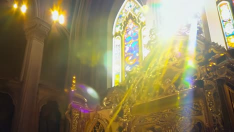 sunbeams illuminating the ornate altar and stained glass windows create a serene atmosphere inside a church