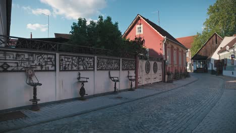 quiet, cobblestone street with historic buildings and decorative ironwork in varaždin, croatia