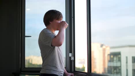 man enjoying coffee and city view