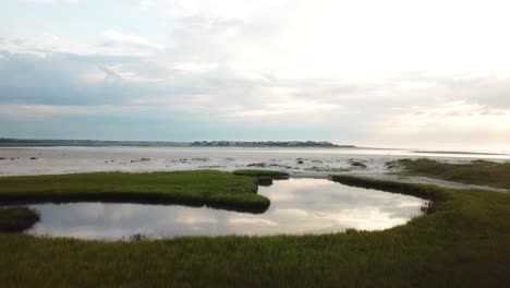 Drone-flyover-of-pool-of-mason-inlet-marsh-and-beach-headed-towards-Figure-Eight-Island-in-Wilmington-North-Carolina