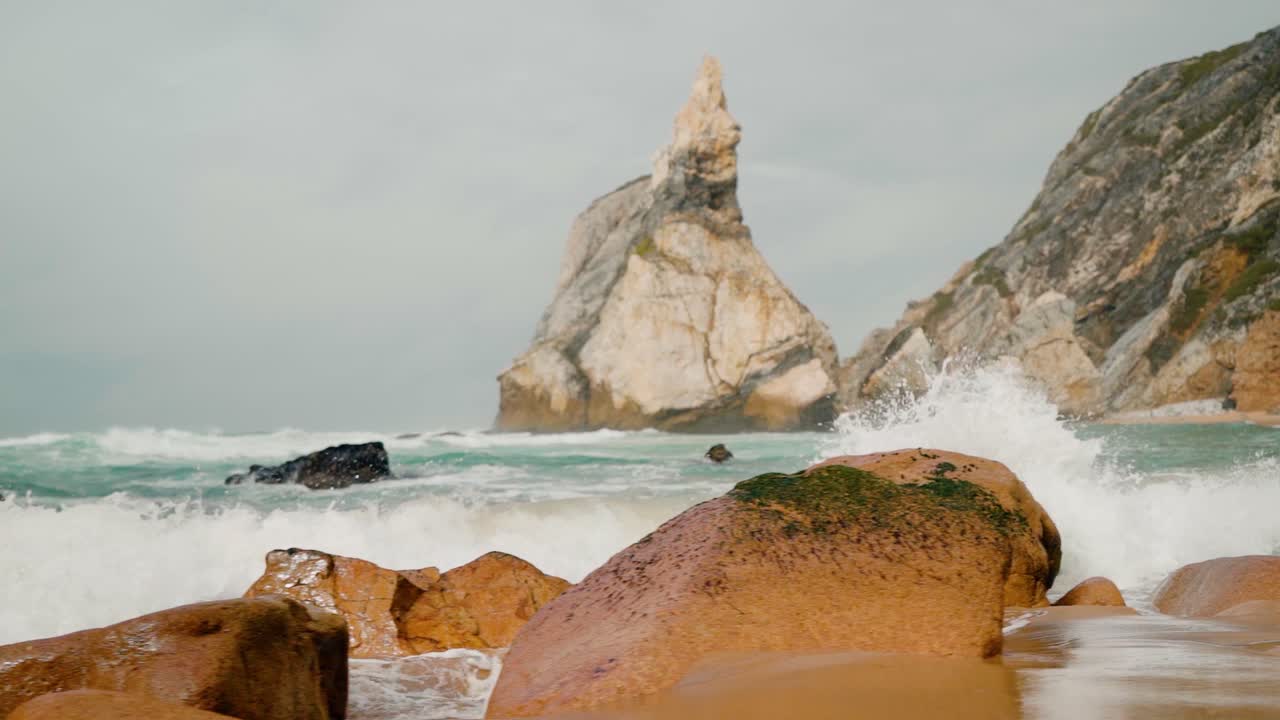 Ocean Waves Crashing on a Rocky Beach with Towering Cliffs