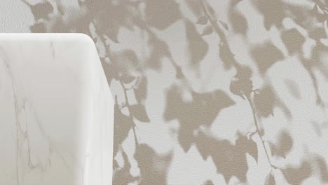 white marble pedestal with shadow of branches on a white background