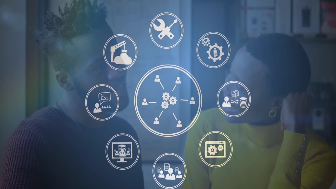 animación de iconos digitales girando sobre un hombre y una mujer afroamericanos hablando en la oficina