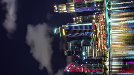 vertical format night timelapse of singapore financial district buildings