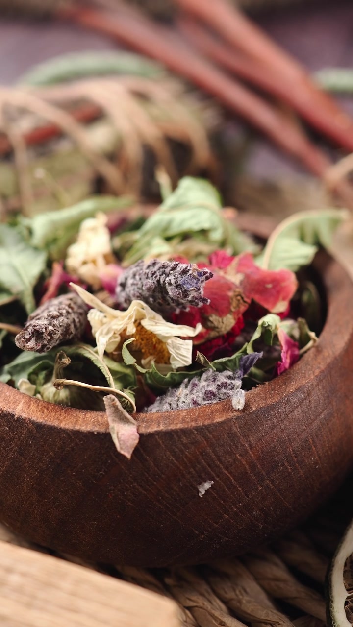 Close-up of Dried Flowers and Herbs in a Rustic Wooden Bowl