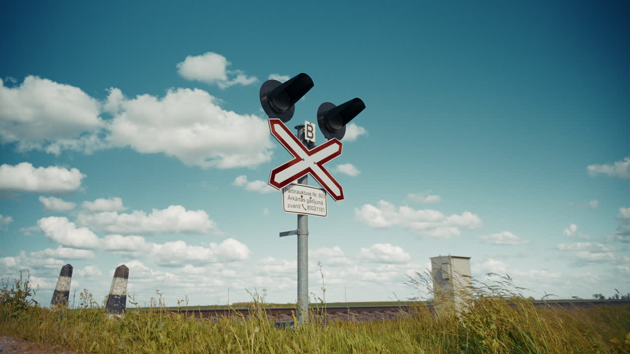 Railway Crossing with Signals under Cloudy Sky