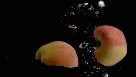 apple falling into water super slowmotion, black background, lots of air bubbles, 4k240fps