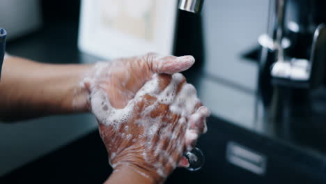 skincare, soap and person washing hands in kitchen