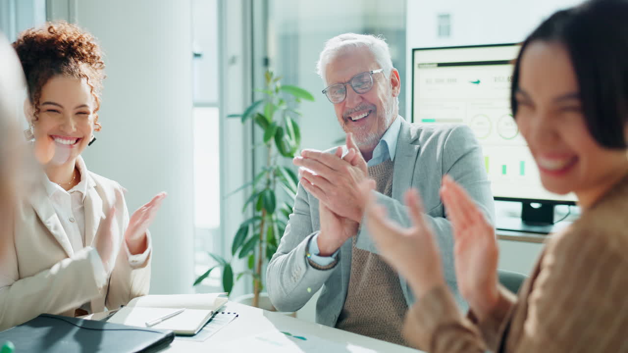 Business team applauding success in office
