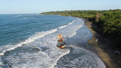 Costa-Rica-beach-drone-view-showing-sea,-shore-and-a-stranded-ship