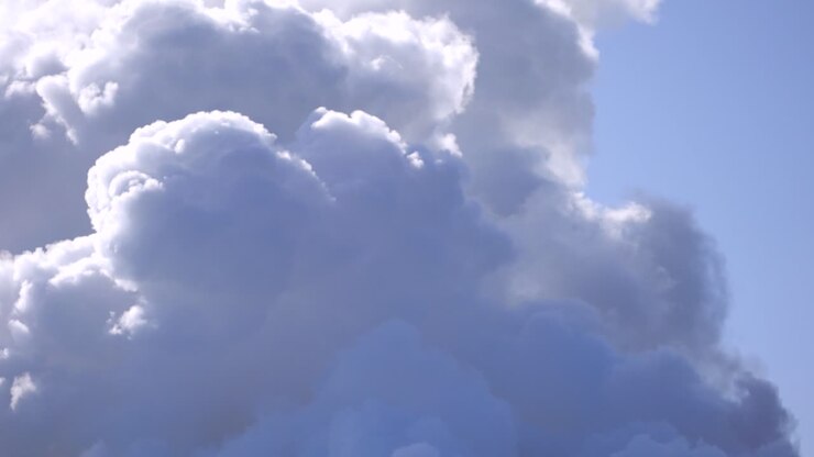 Dense smoke from a geothermal plant chimney burning fossil fuels to produce electricity, Revealing shot
