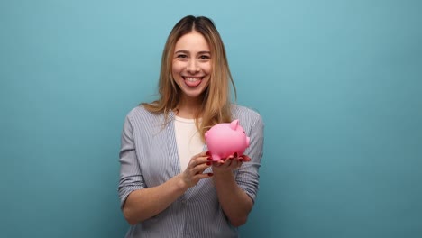 woman with wavy hair holding piggy bank and putting banknote into money box, profitable investment.
