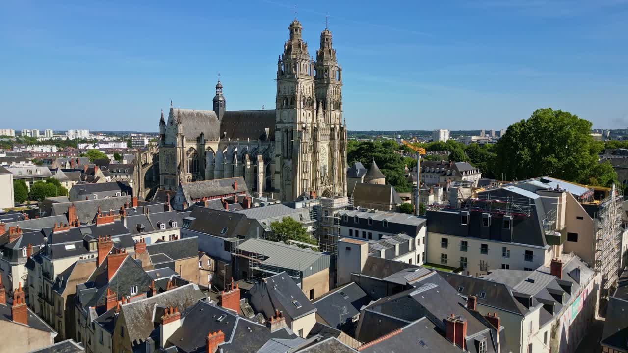 Drone rising forward shot revealing Saint-Gatien Cathedral and cityscape of Tours under clear blue sky