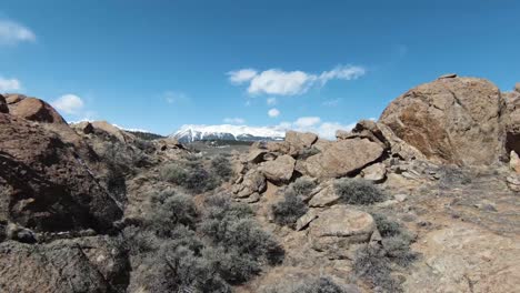 4k aerial video diving down rocky mountain