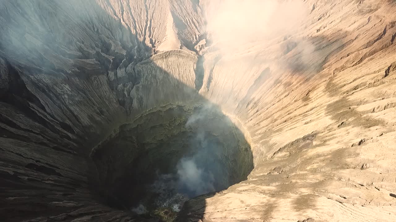 Active volcano center captured by drone. Bromo volcano steaming sierra steams captured from the top clearly seeing what is in the middle. Location: Bromo volcano, Indonesia.