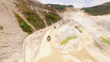 aerial view of quarry with trucks
