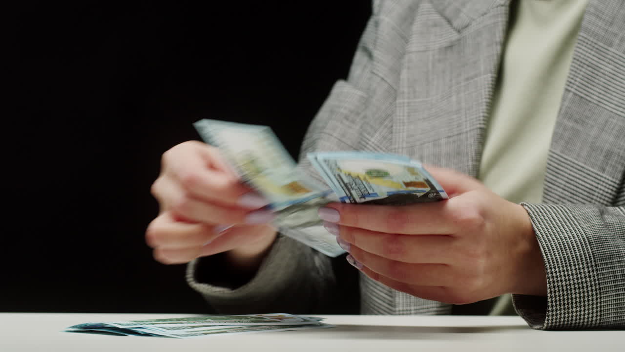 Hands Counting Hundred Dollar Bills