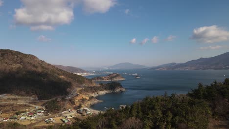 beautiful aerial reveal of south korean coastal landcape, town of namhae on shore