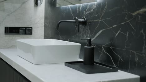 modern bathroom detail with marble backsplash and designer sink