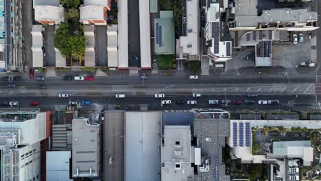 aerial view of a city street with buildings and cars