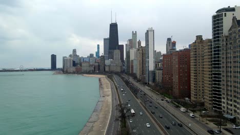 Aerial-view-Chicago-downtown-John-Hancock-Center,-traffic-cars-passing-by