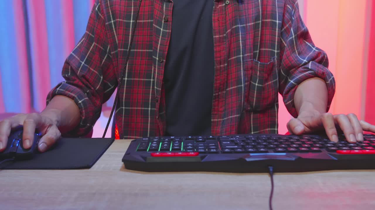 Gamer playing video games on a desktop computer