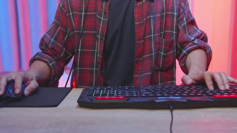 Gamer playing video games on a desktop computer