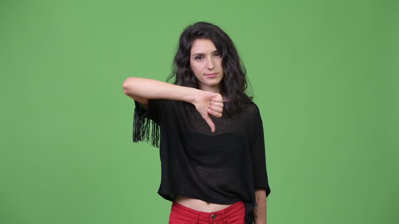 Young beautiful woman giving thumbs down