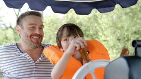 Father-And-Son-Enjoy-Ride-In-River-Boat-Shot-In-Slow-Motion
