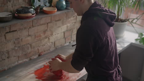 person working with clay in a pottery studio