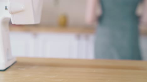 girl takes glass bowl of homemade organic flour from table