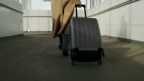 woman with suitcase walking in an airport